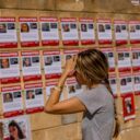 A woman looks on pictures of of kidnapped people outside of the Israeli military base of The Kirya in Tel Aviv, 18 October 2023. Israel has warned all citizens of the Gaza strip to move to the south ahead of an expected invasion. More than 2,750 Palestinians and 1,300 Israelis have been killed according to the IDF and Palestinian health ministry, after Hamas militants launched an attack against Israel from the Gaza Strip on 07 October.